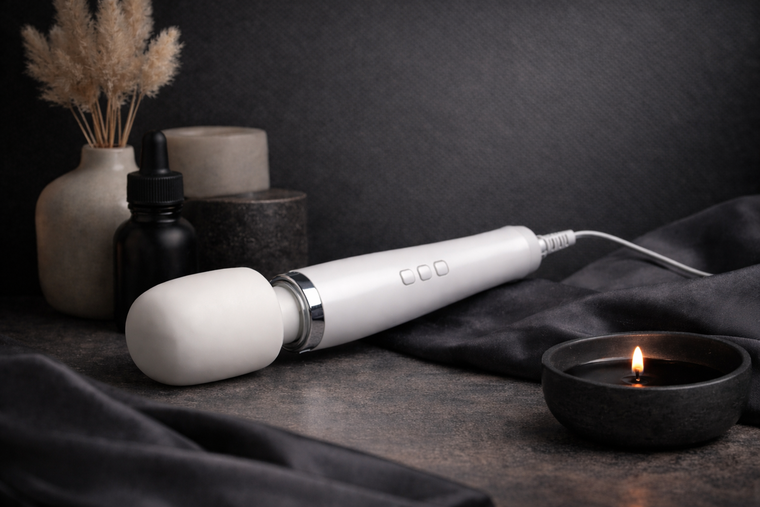 Velore Wellness modern self-care massager with candle and decor on spa-inspired background
